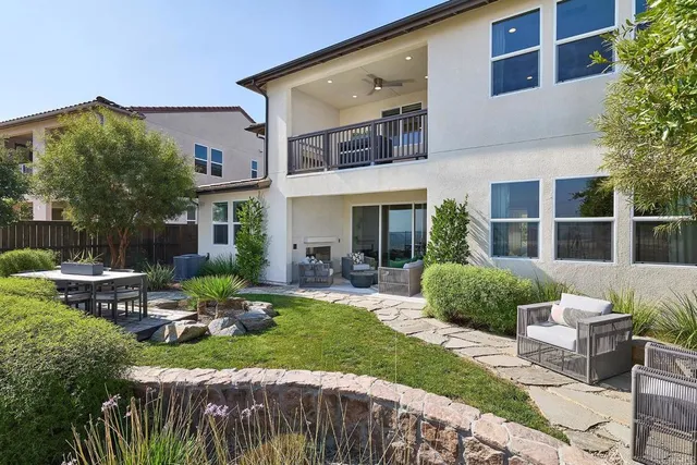 a view of a house with backyard and sitting area