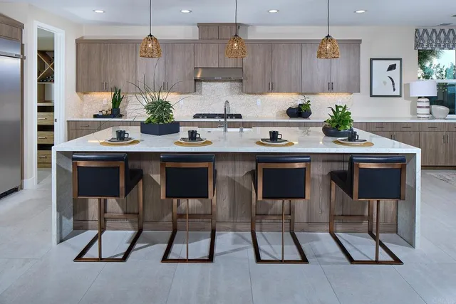 a kitchen with a sink and chairs