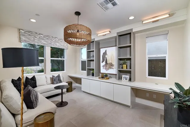 a living room with furniture a large window and a flat screen tv