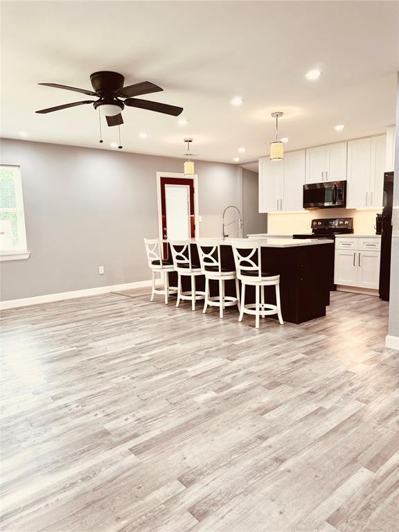 10065 Comanche Road Quinlan, TX 75474 - Photo 10 of 36 a large white kitchen with lots of counter space and stainless steel appliances
