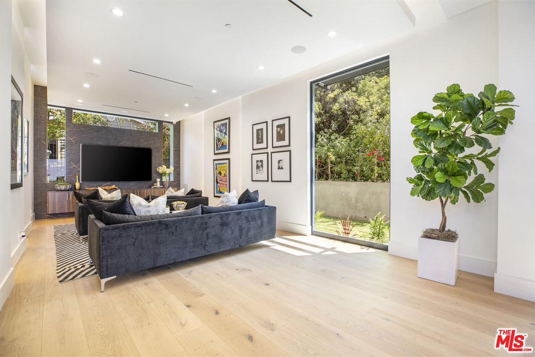 1754 Clear View Drive Beverly Hills, CA 90210 - Photo 11 of 37 a living room with furniture and a flat screen tv
