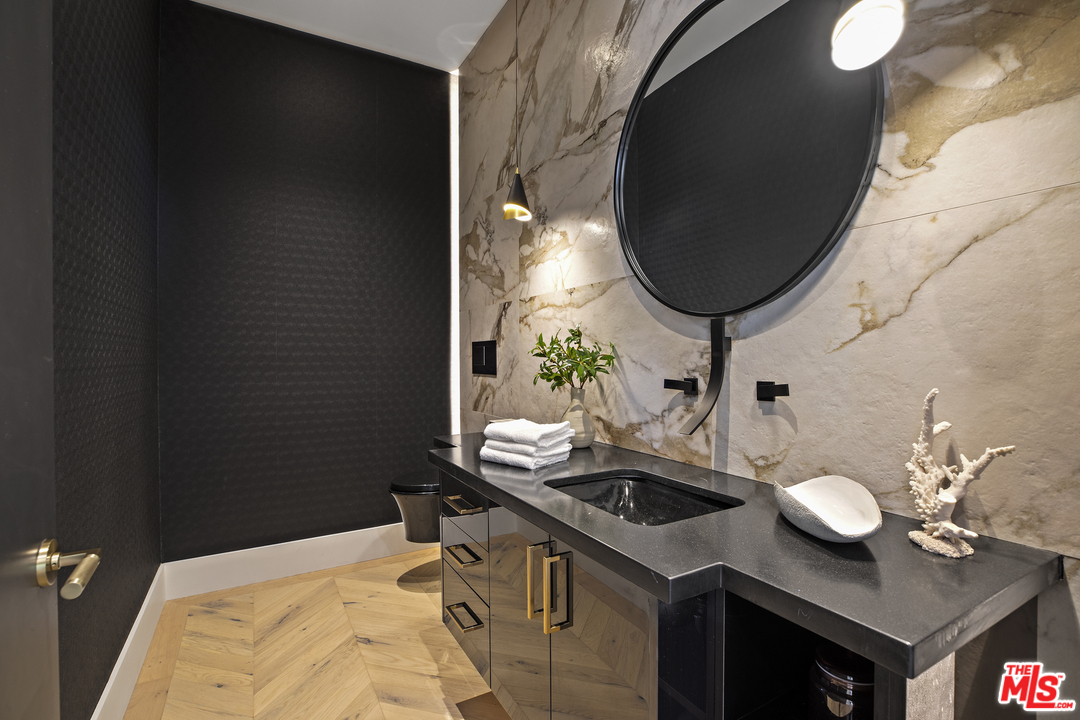 1754 Clear View Drive Beverly Hills, CA 90210 - Photo 12 of 37 a bathroom with a sink and a mirror