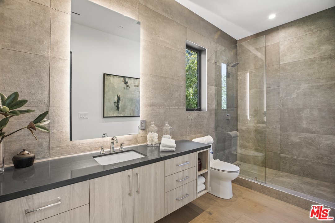 1754 Clear View Drive Beverly Hills, CA 90210 - Photo 16 of 37 a bathroom with a double vanity sink toilet and shower