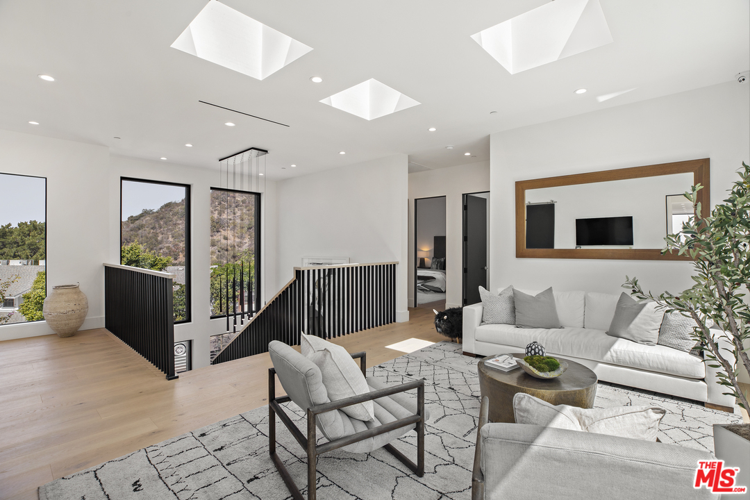 1754 Clear View Drive Beverly Hills, CA 90210 - Photo 18 of 37 a living room with furniture and a flat screen tv