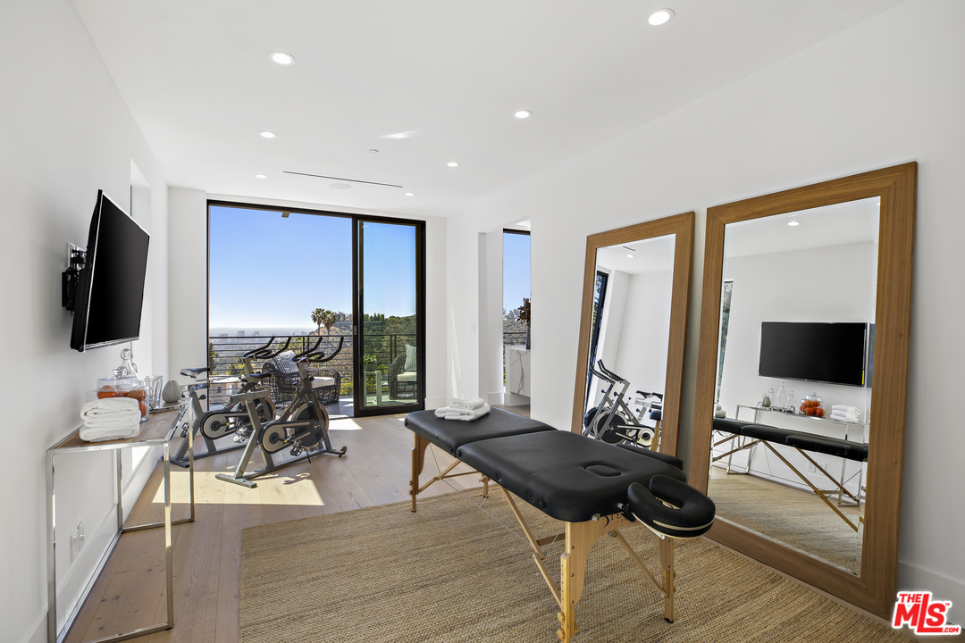 1754 Clear View Drive Beverly Hills, CA 90210 - Photo 19 of 37 a living room with furniture and a flat screen tv