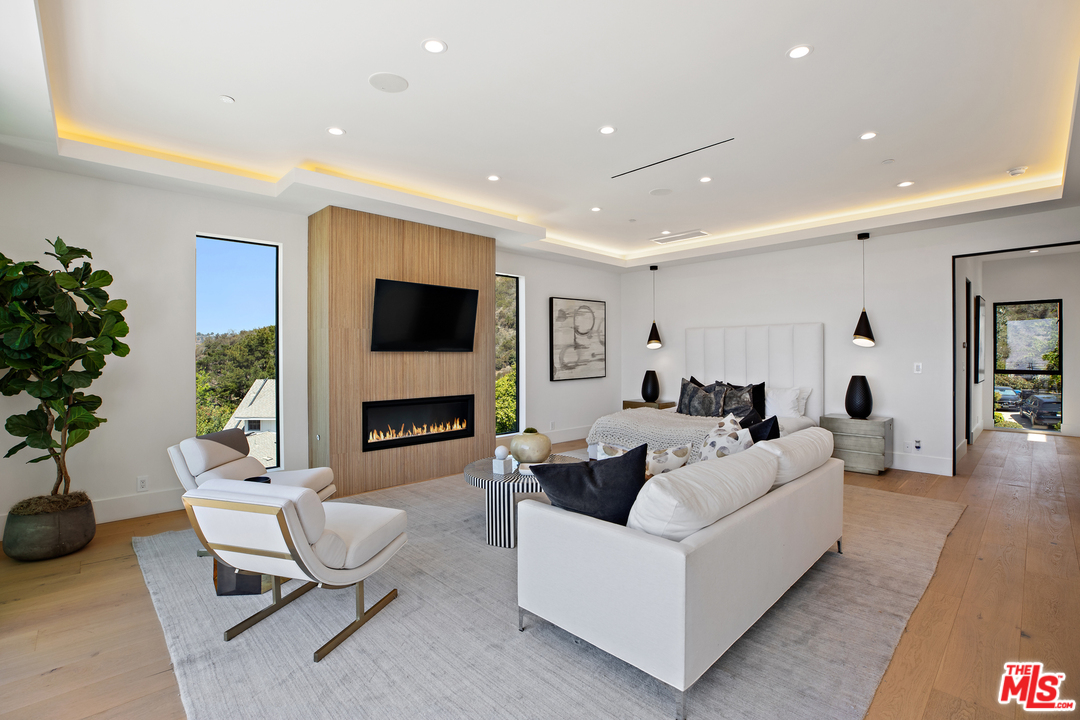 1754 Clear View Drive Beverly Hills, CA 90210 - Photo 24 of 37 a living room with fireplace furniture and a flat screen tv