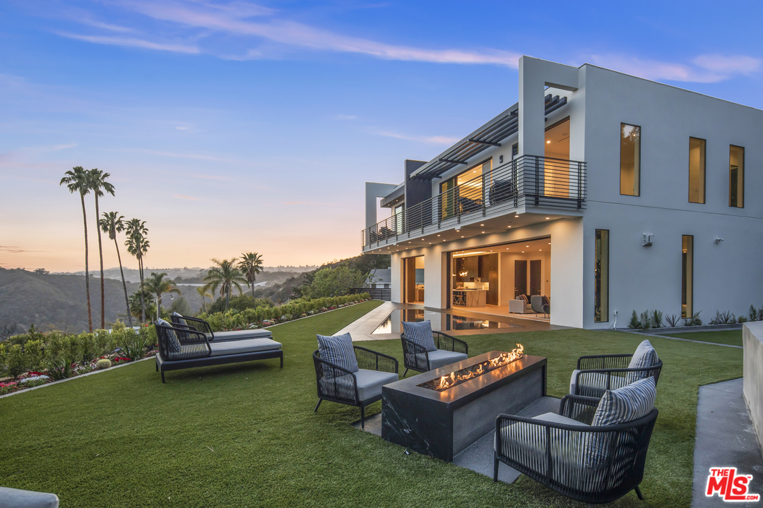1754 Clear View Drive Beverly Hills, CA 90210 - Photo 30 of 37 a view of a patio with couches table and chairs with garden view