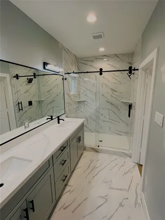 a bathroom with a shower and a sink