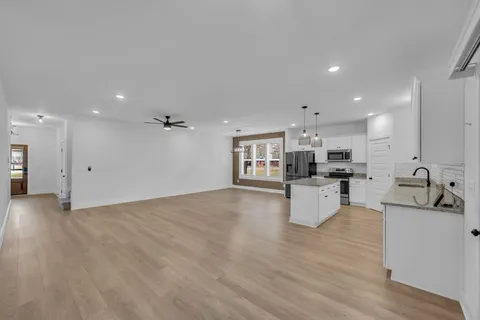 a view of kitchen with kitchen island white cabinets and refrigerator