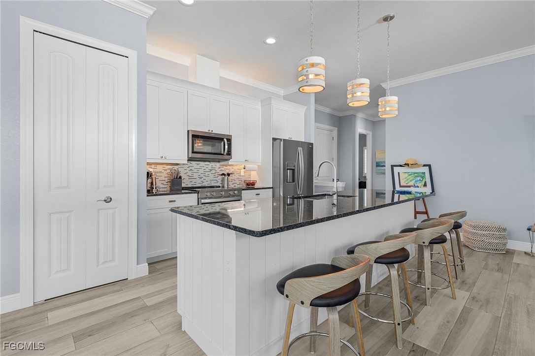 2265 York Road St. James City, FL 33956 - Photo 11 of 39 a kitchen with cabinets a sink and stainless steel appliances
