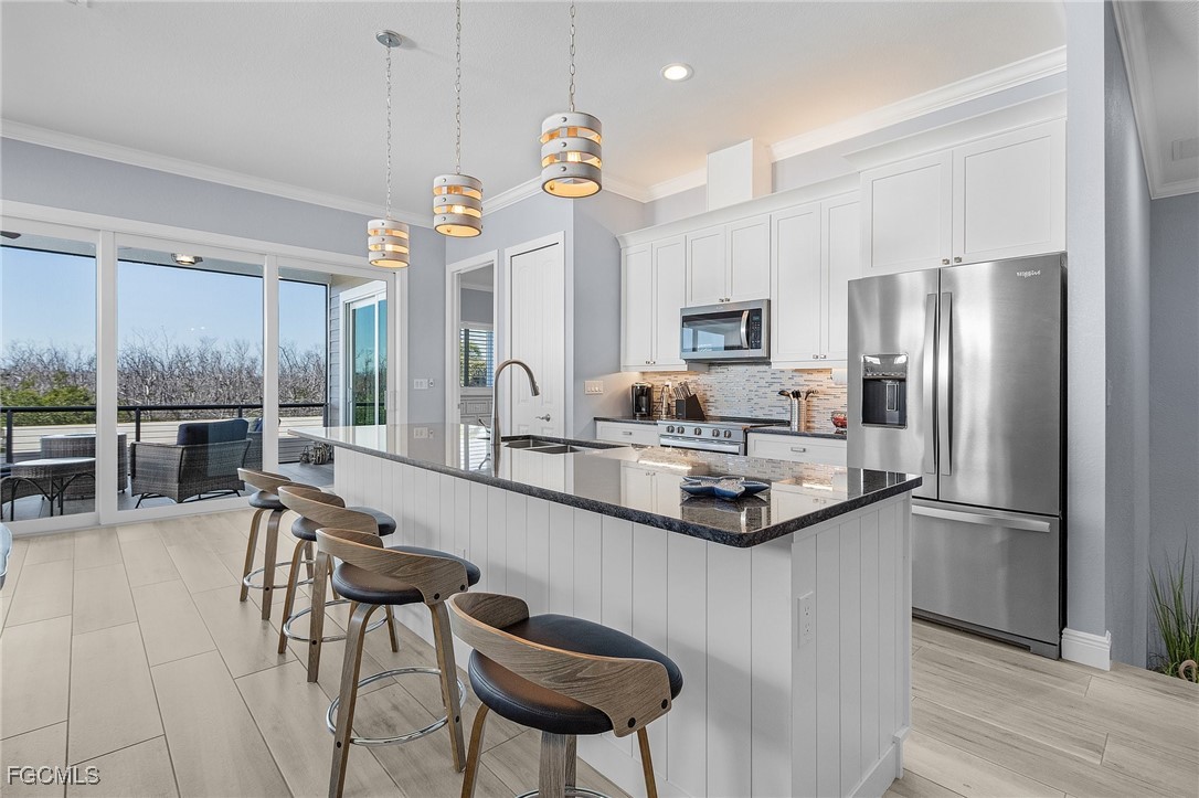 2265 York Road St. James City, FL 33956 - Photo 12 of 39 a kitchen with kitchen island a large counter top space appliances and cabinets