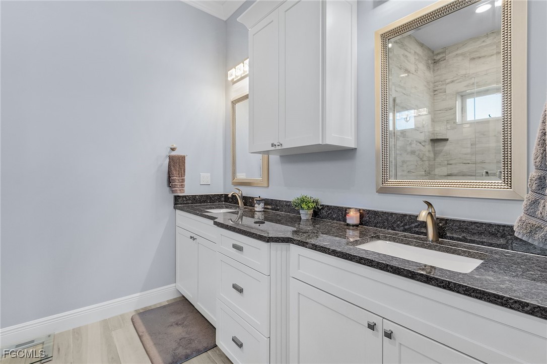 2265 York Road St. James City, FL 33956 - Photo 18 of 39 a bathroom with a granite countertop sink and a mirror