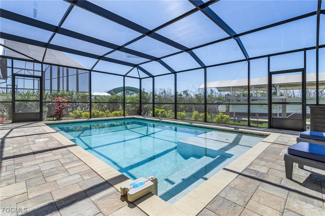 2265 York Road St. James City, FL 33956 - Photo 2 of 39 a view of swimming pool with a lounge chairs in front of building