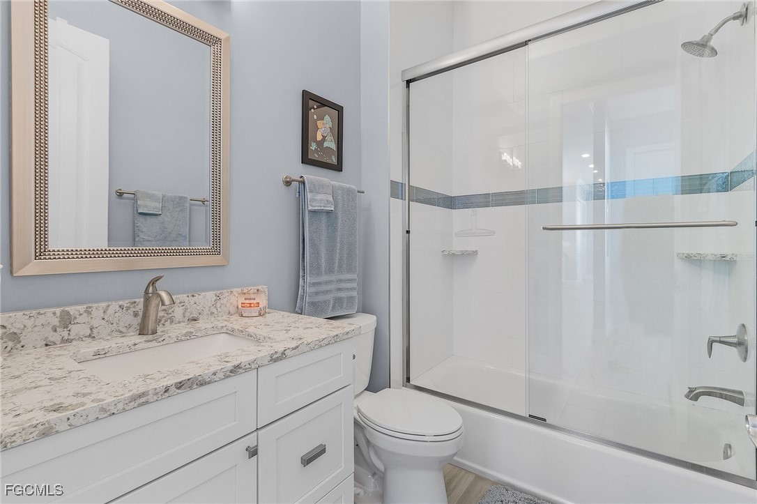 2265 York Road St. James City, FL 33956 - Photo 21 of 39 a bathroom with a granite countertop sink toilet and shower