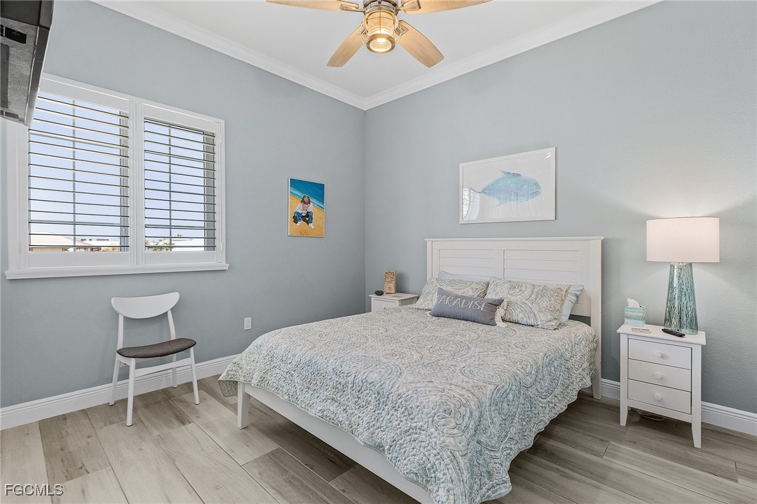 2265 York Road St. James City, FL 33956 - Photo 22 of 39 a bedroom with a bed and a chandelier