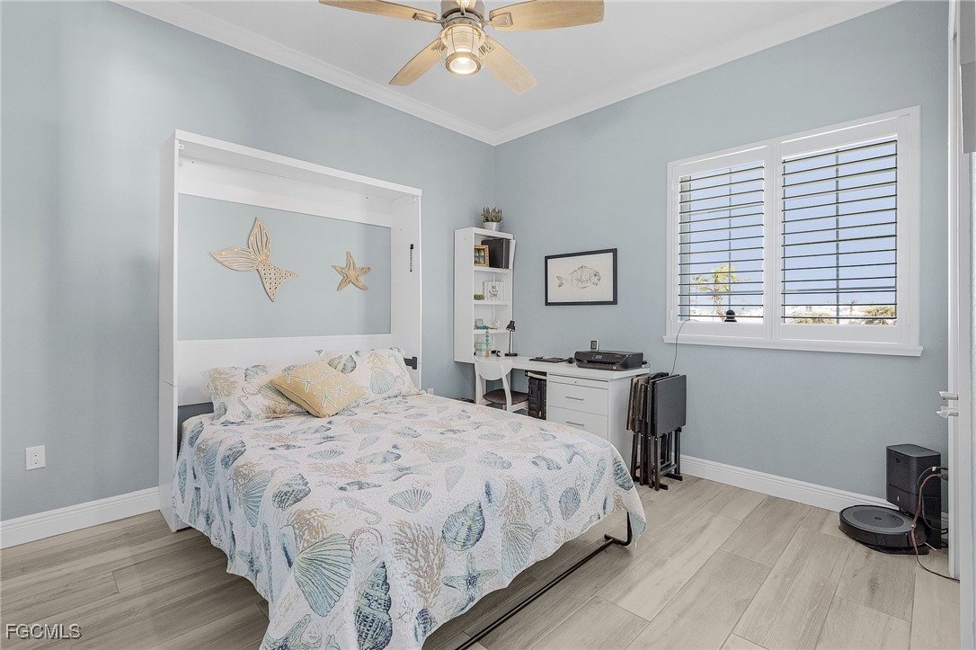 2265 York Road St. James City, FL 33956 - Photo 25 of 39 a bedroom with a bed and a table in it