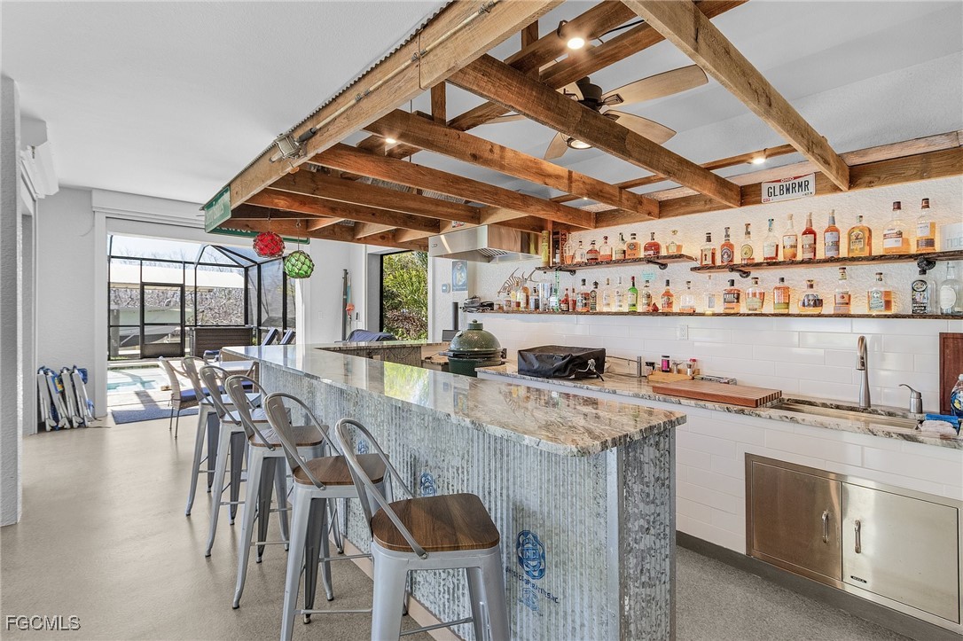 2265 York Road St. James City, FL 33956 - Photo 27 of 39 a dining hall with stainless steel appliances granite countertop a stove a sink a dining table and chairs with wooden floor