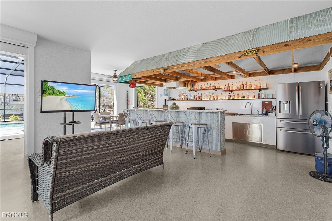 2265 York Road St. James City, FL 33956 - Photo 28 of 39 a kitchen with stainless steel appliances wooden floor and a refrigerator