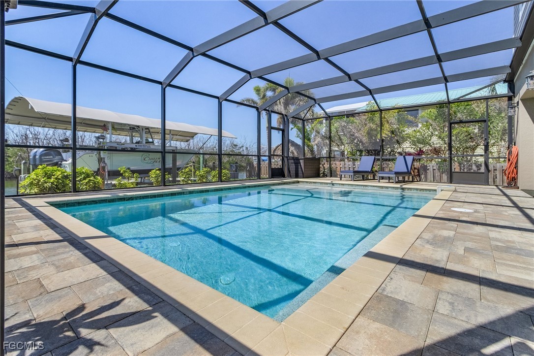 2265 York Road St. James City, FL 33956 - Photo 31 of 39 a view of a patio with a table and chairs under an umbrella
