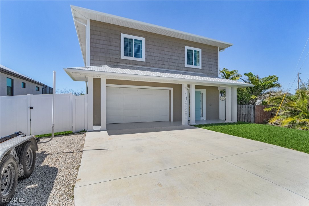 2265 York Road St. James City, FL 33956 - Photo 5 of 39 a front view of a house with a yard and garage
