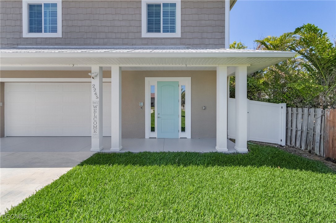 2265 York Road St. James City, FL 33956 - Photo 7 of 39 a front view of a house with a yard and garage