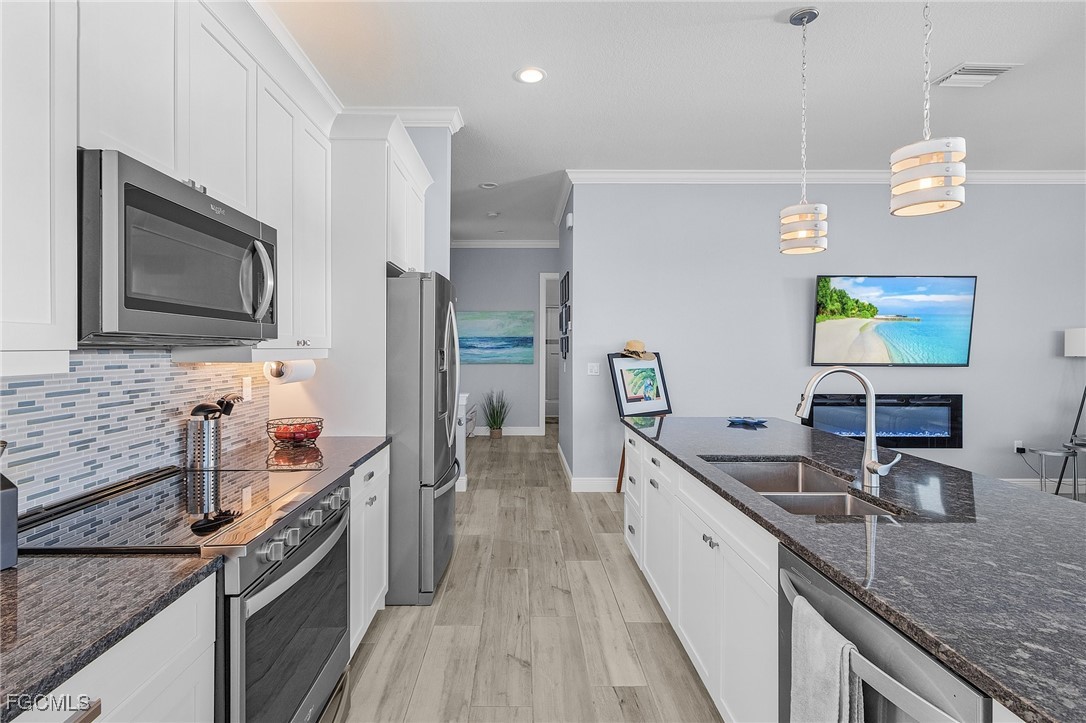 2265 York Road St. James City, FL 33956 - Photo 10 of 39 a large kitchen with a stove and a sink