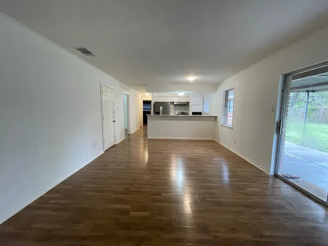 a view of a kitchen with wooden floor and a kitchen