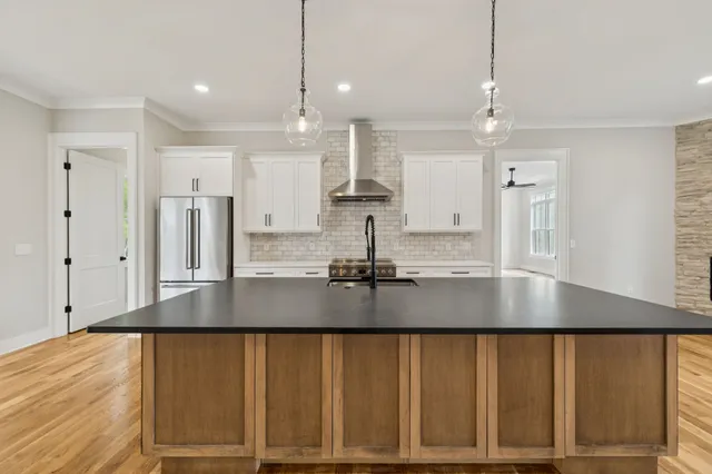 a kitchen with stainless steel appliances a sink stove and cabinets