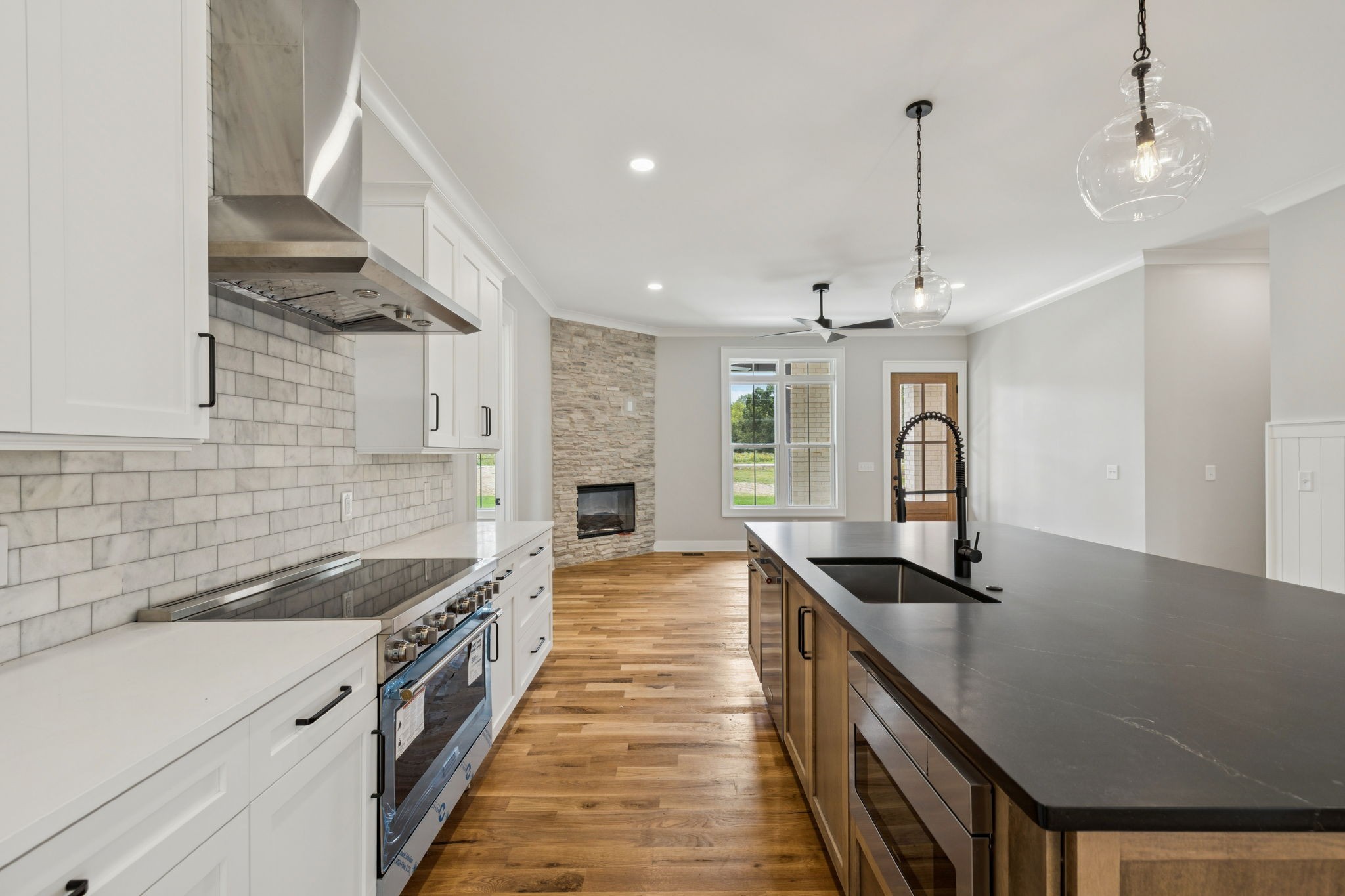 8297 12 Corners Road Lascassas, TN 37085 - Photo 14 of 63 a kitchen with granite countertop a sink stainless steel appliances and cabinets