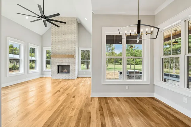 a bedroom with a bed and a chandelier fan