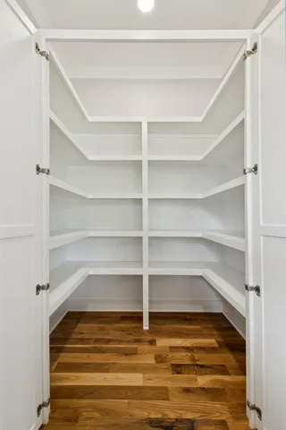 a view of an empty room with a ceiling fan and window