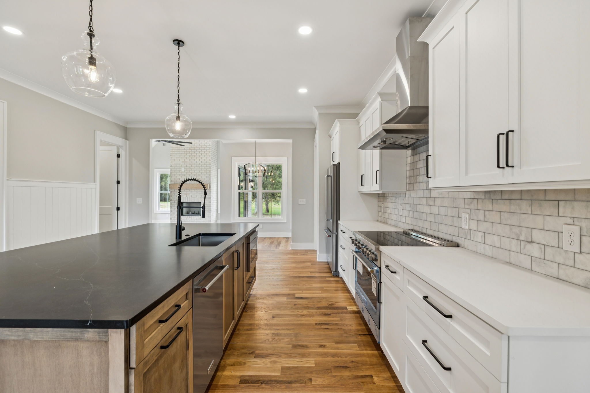 8297 12 Corners Road Lascassas, TN 37085 - Photo 9 of 63 a kitchen with stainless steel appliances granite countertop a sink a stove and a wooden floors