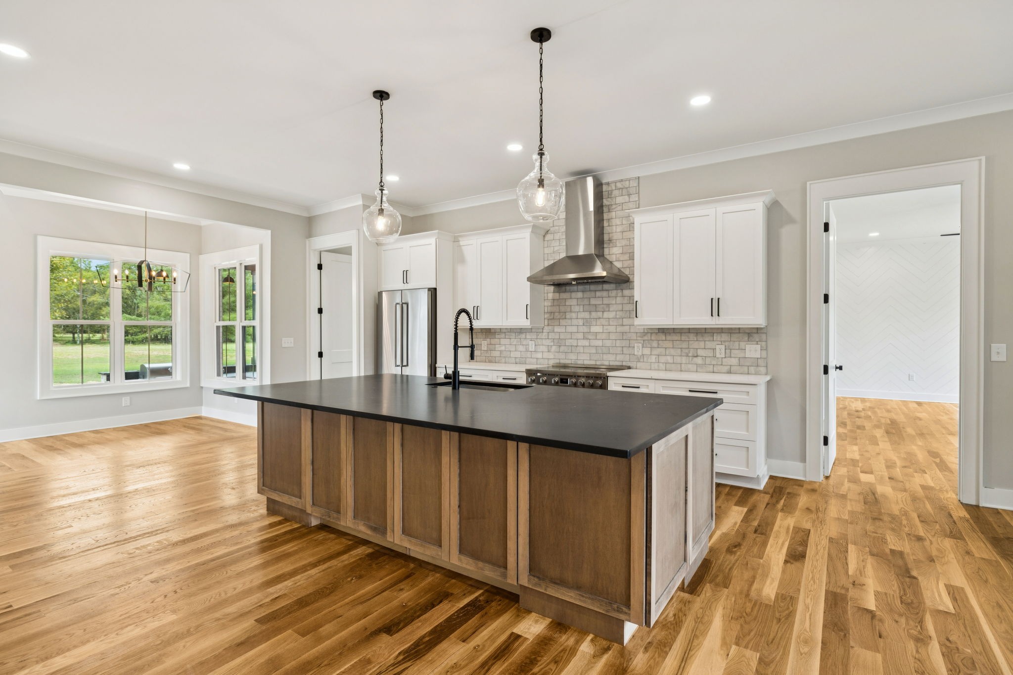 8297 12 Corners Road Lascassas, TN 37085 - Photo 10 of 63 a kitchen with stainless steel appliances granite countertop a sink a stove and a wooden floors