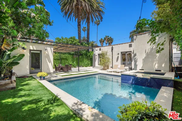 a view of a house with pool and sitting area