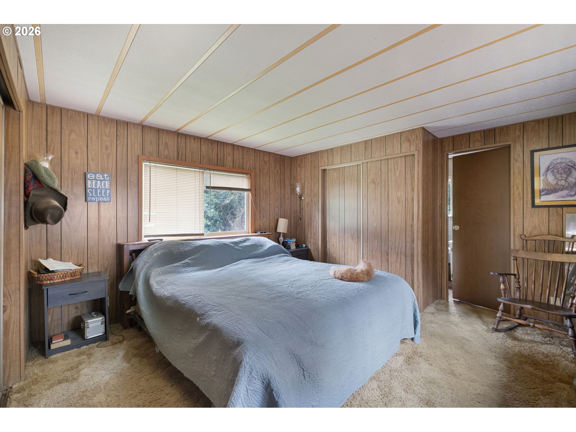 4826 Rhododendron Loop Florence, OR 97439 - Photo 24 of 41 a bedroom with a bed and a chair