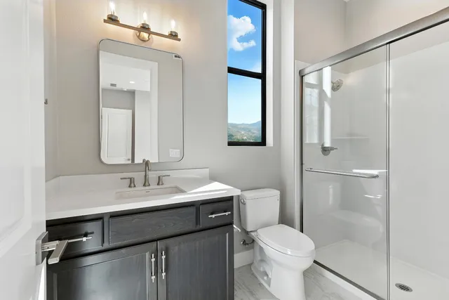 a bathroom with a sink toilet and shower