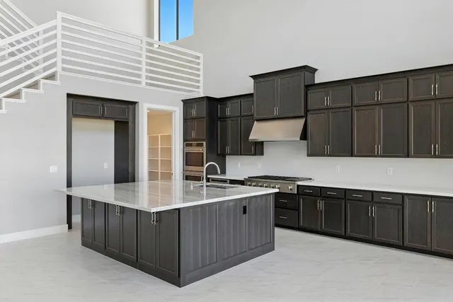 a kitchen with stainless steel appliances granite countertop a sink and cabinets