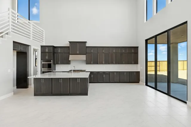 a living room with a large window and furniture