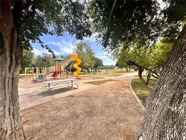 a view of a park with swings and slides