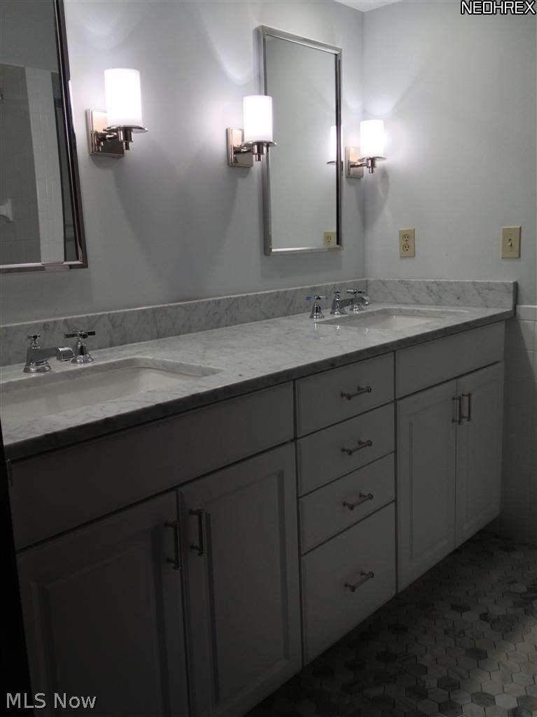 12501 Fairhill Road Cleveland, OH 44120 - Photo 14 of 25 The newly updated master bath features, Carrara marble countertops and floor tiles and has two sinks, separate tub and stall shower.