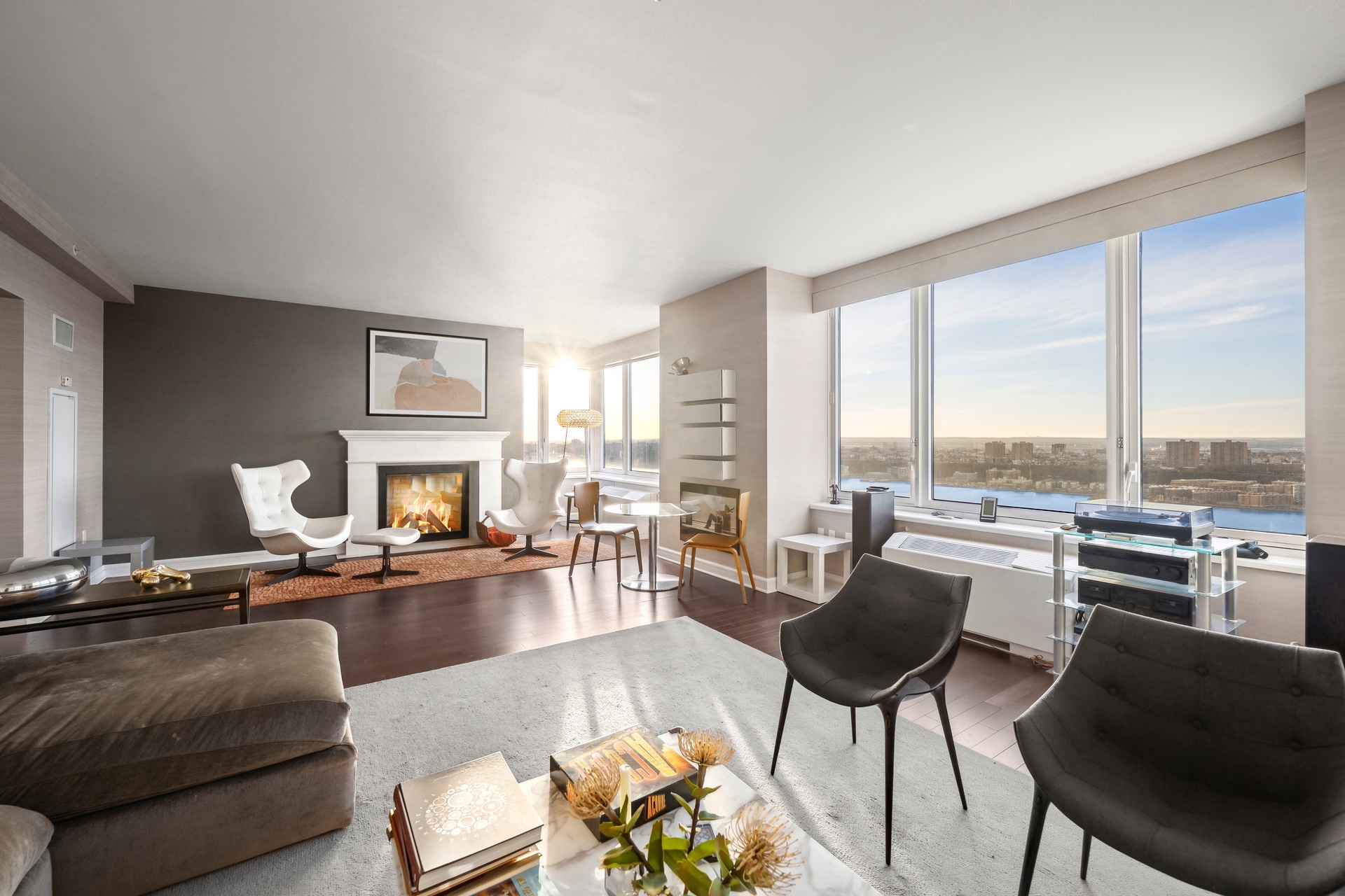 a living room with furniture kitchen view and large windows