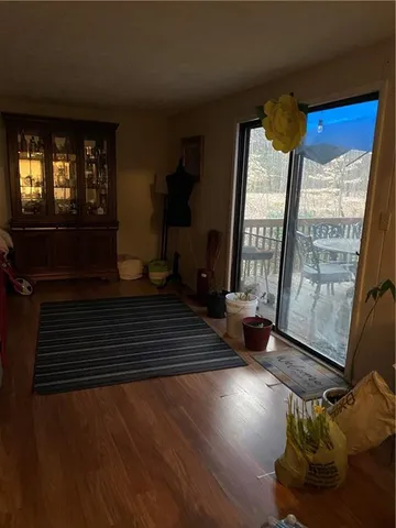 a view of an entryway with wooden floor