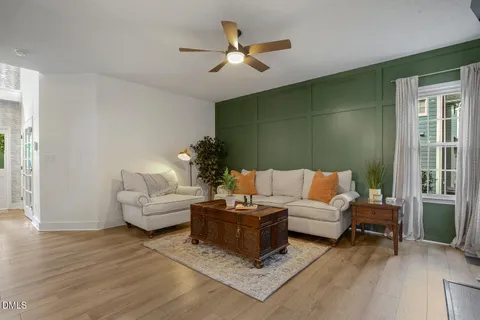 a living room with furniture and a book shelf