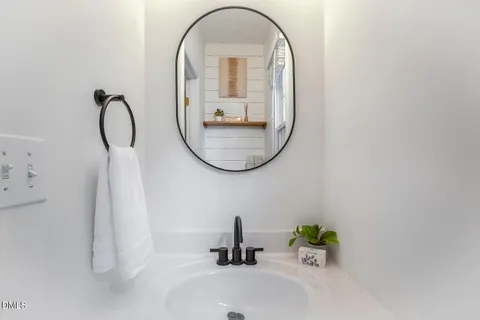 a white cabinet sitting in a kitchen next to a window