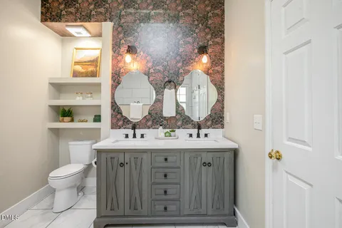 an empty room with windows & cabinet