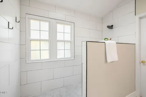 an empty room with closet and windows