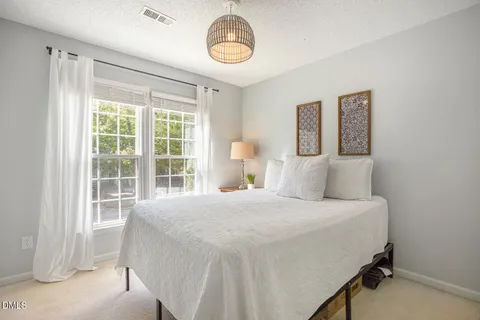 a view of a house with a patio and a yard