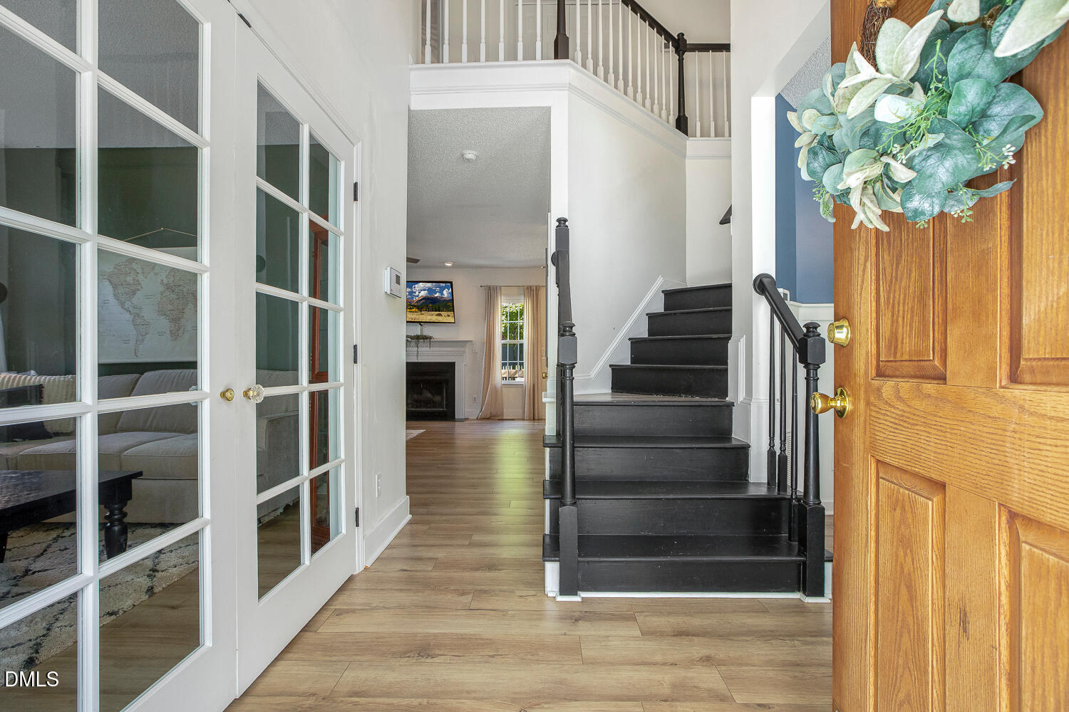 5233 Fairmead Circle Raleigh, NC 27613 - Photo 5 of 68 a view of a hallway with wooden floor and staircase