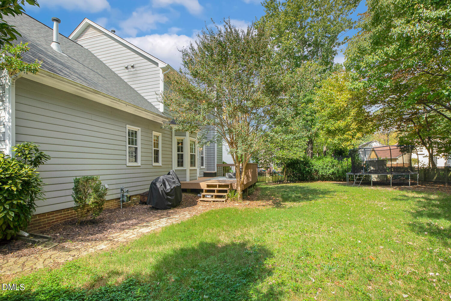 5233 Fairmead Circle Raleigh, NC 27613 - Photo 56 of 68 a backyard of a house with table and chairs and potted plants