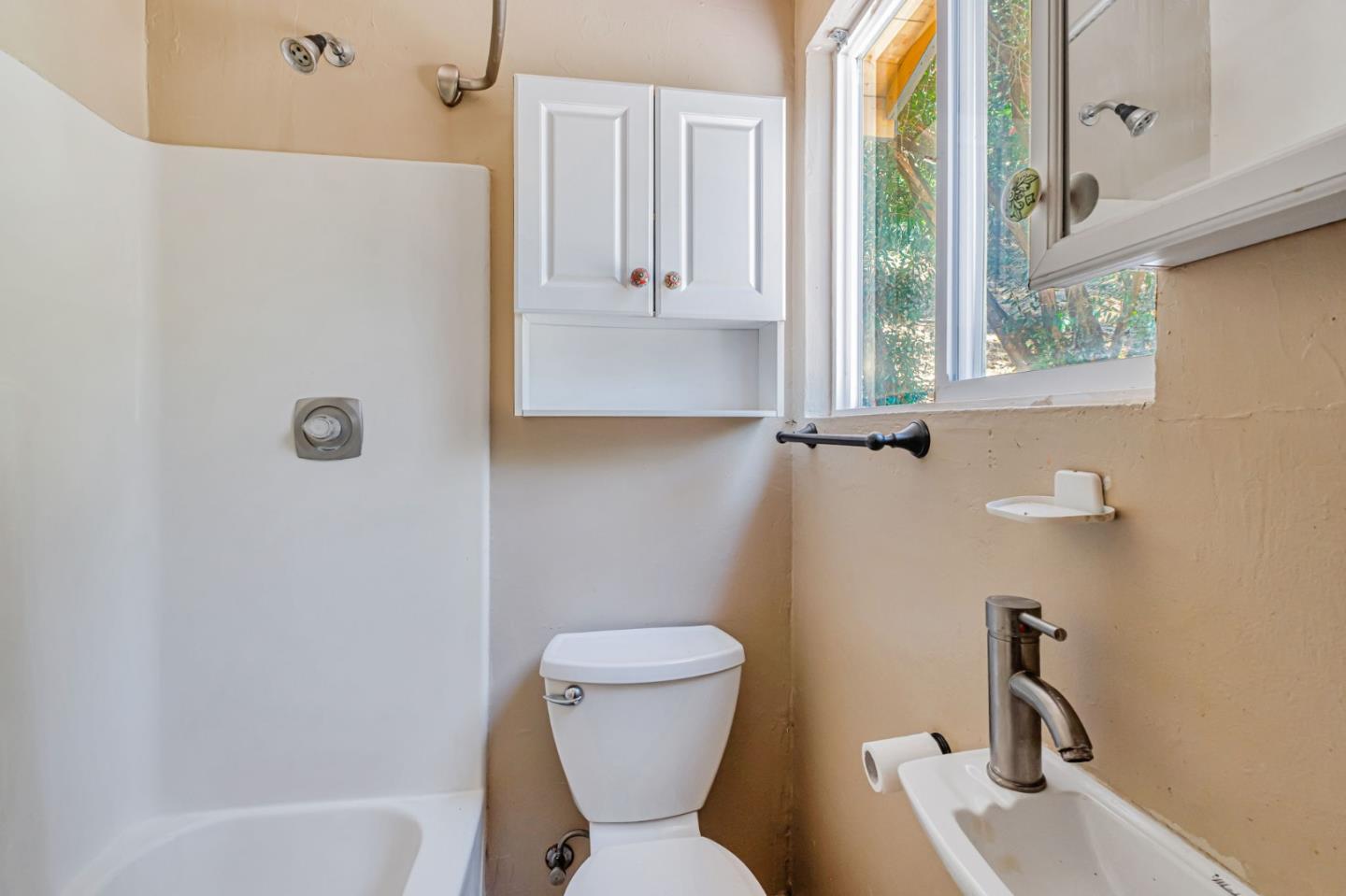 4858 Freedom Boulevard Aptos, CA 95003 - Photo 65 of 65 a bathroom with a toilet sink and mirror